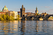 Charles Bridge and the Old Town Bridge Tower seen from the banks of Vltava River, UNESCO World Heritage Site, Prague, Bohemia, Czech Republic, Europe