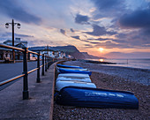Sunrise looking along the beach at the picturesque seaside town of Sidmouth, Devon, England, United Kingdom, Europe