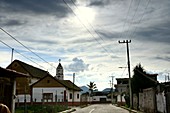 Village street with church and palm tree in the back light in a village at the volcano Popocatepetl at Amecameca, eastern Mexico
