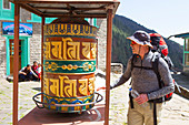 A hiker is turning a Buddhist prayer wheel along the way to Everest Base Camp. The trek to Everest Base Camp (EBC) is possibly the most dramatic and picturesque in the Nepalese Himalaya. Not only will you stand face to face with Mount Everest, Sagarmatha in Nepali language, at 8,848 m (29,029 ft), but you will be following in the footsteps of great mountaineers like Edmund Hillary and Tenzing Norgay. The trek is scenic and offers ever-changing Himalayan scenery through forests, hills and quaint villages. A great sense of anticipation builds as you trek up the Khumbu Valley, passing through int