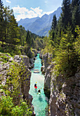 Kayakers on Soca river originating in Trigval mountains. The river is famous for all kinds of white water activities, Triglav National Park, Slovenia