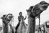 Mongolian woman riding camel, Kharakhorin, Mongolia