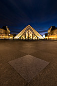 Courtyard of the Louvre with a view of the illuminated pyramid at the blue hour, Paris, Île-de-france, France