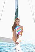 Portrait confident woman in bathing suit on sunny sailboat