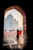 A lady twirls as the sun rises behind the Taj Mahal, UNESCO World Heritage Site, Agra, Uttar Pradesh, India, Asia