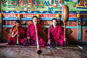 Asian monks playing instruments on temple floor, Bhutan, Kingdom of Bhutan