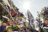 Climber hikes with backpack to start climbing. Galtigentürme. Pilate. Lucerne. Switzerland. Europe.