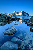 Verschneite Berge spiegeln sich in See, Vareid, Lofoten, Nordland, Norwegen
