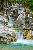 Mountain stream flows with waterfalls through bright gorge, Val Cimoliana, Dolomites, UNESCO World Heritage Dolomites, Veneto, Italy