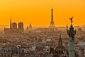 France, Paris, area listed as World Heritage by UNESCO, general view of Paris at sunset with the July Column (Colonne de Juillet) at Place de la Bastille, the Notre Dame cathedral on the Ile de la Cite, the Eiffel Tower, the Invalides dome and the Saint Germain des Pres church