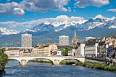 France, Isere, Grenoble, the banks of the Isere river, the 13th century Saint Andre church and Belledonne massif in the background