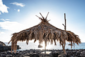 Palm umbrella on the stone beach of la Bombilla, La Palma, Canary Islands, Spain, Europe