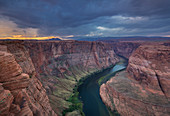 Colorado River on Horseshoe Bend in sunset after thunderstorm, USA