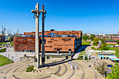The European Solidarity Centre, museum and library in Gdansk, Poland, devoted to the history of Solidarity, the Polish trade union and civil resistance movement, and other opposition movements of Communist Eastern Europe. The Monument to the fallen Shipyard Workers 1970. Famous old gate to the shipyard. www.ecs.gda.pl Architecture by FORT Architects. Gdansk, Pomorze region, Pomorskie voivodeship, Poland, Europe