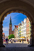Gdansk, Main City, old town, Dlugi Targ street (Long Market), City Hall with tower, view from the arch of Zielona (Green) gate. Gdansk, Main City, Pomorze region, Pomorskie voivodeship, Poland, Europe