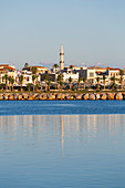 View to the waterfront, early morning, minaret of the Neratzes Mosque reflected in water, Rethymno (Rethymnon), Crete, Greek Islands, Greece, Europe