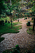 Gravel path with concentric patterns at a zen rock garden.