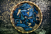 High angle close up of basket with indigo leaves used to dye cotton.