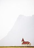Isolated church with hazy outline of distant mountain in the background, Snaefellsnes Peninsula, Iceland, Polar Regions