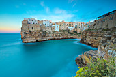Turquoise sea at sunset framed by the old town perched on the rocks, Polignano a Mare, Province of Bari, Apulia, Italy, Europe