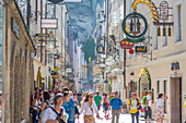 View of shoppers and signs on Getreidegasse, Salzburg, Austria, Europe