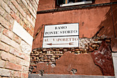 Signpost to the vaporettto on house facade, Venice, Italy