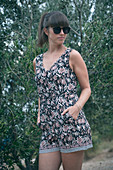 Woman in jumpsuit in front of olive tree, Croatia