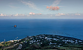 Strombolicchio island with the village of Stromboli on the volcanic island of Stromboli, Sicily Italy