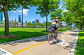 View of Chicago skyline and cyclist on South Lake Shore Drive, Chicago, Illinois, United States of America, North America
