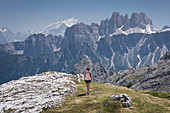 Woman hikes to Cinque Torri in the Dolomites, South Tyrol