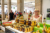 Market woman sells honey in the market hall Les Halles, Redon, Ille-et-Vilaine department, Brittany, France, Europe