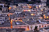 Evening view of the lower town, lights, Modica, southern Sicily, Italy