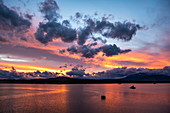 The last rays of the sun paint the sky and the clouds with intense colors, Puerto Natales, Magallanes y de la Antartica Chilena, Patagonia, Chile, South America