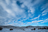 Snowy hills under cloud