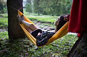 Woman lying in hammock in Appenzell, Switzerland