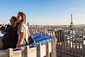 France, Paris, tourists on the terrace of the Arc de Triomphe and the Eiffel Tower