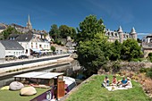 France, Morbihan, Josselin, A picnic family by the canal from Nantes to Brest overlooked by the castle of Rohan