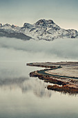 Lake Silvaplana at fog in the sunrise in the Upper Engadine, Sankt Moritz im Engadin, Switzerland