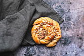A platted glazed fresh baked cinnamon bun.