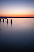 View of the Ammersee at sunset, left wooden pillar from the jetty, Bavaria, Germany, Europe
