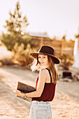 Woman reads book in Joshua Tree National Park, Joshua Tree, Los Angeles, California, USA, North America