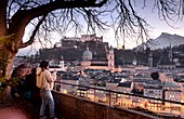 Evening view from Kapuzinerberg, tourists, city view, panorama, branches, lights, river, castle, cathedral, reflections, Stadthäuserm Salzburg in winter, Austria
