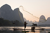 Cormorant Fisherman Throwing Fish Net on River Li\nGuilin Region\nGuangxi, China\nLA008327\n