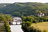 The Dordogne river with Castelnaud-la-Chapelle and Fayrac castles in the evening viewed from Beynac-et-Cazenac village, Perigord Noir, Dordogne France.