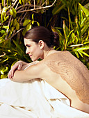 Caucasian woman having mud spa treatment