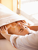 Woman lying on massage table receiving shoulder massage at a luxury spa in Napa Valley California