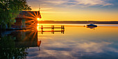 Boothaus silhouette with jetty at sunrise on Lake Starnberg, Bavaria, Germany