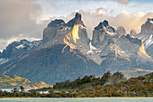 Paine Horns with clouds and Lake Pehoé in the foreground. Torres del Paine National Park, Ultima Esperanza province, Chile.