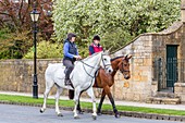 United Kingdom, Worcestershire, Cotswold district, Cotswolds region, Broadway, riders in the main street