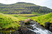 Church with a grassy roof and creek in the foreground, in one of the most beautiful places in the world, Saksun, Streymoy Island in the Faroe Islands.